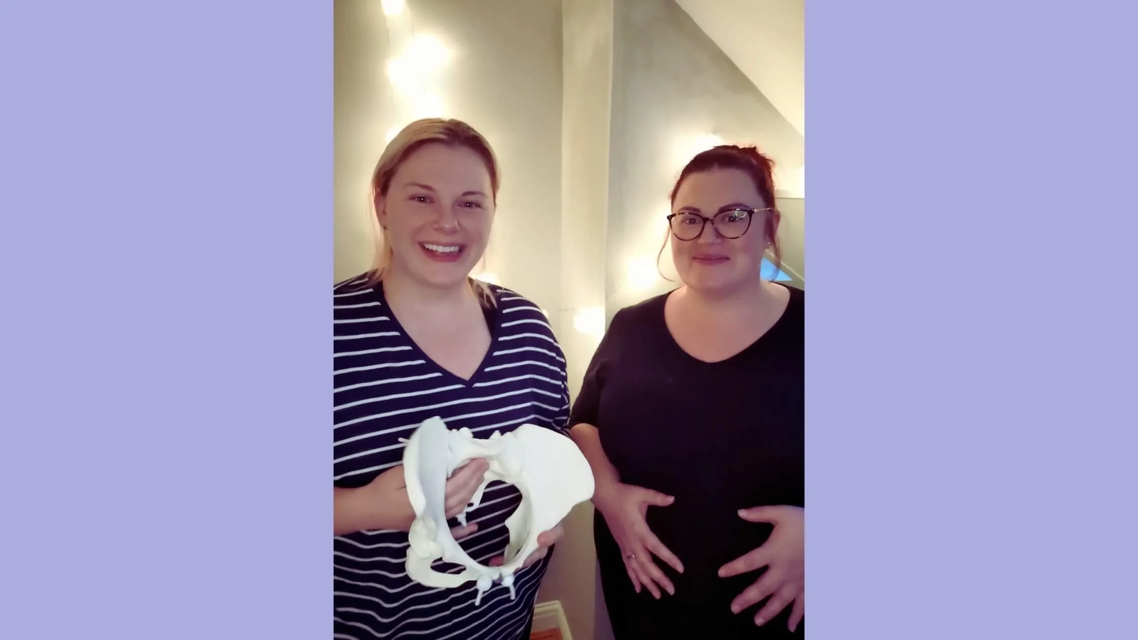 Doula and antenatal educator in Leeds holding pelvic model during antenatal class, supporting a pregnant woman with informed, confident birth preparation.