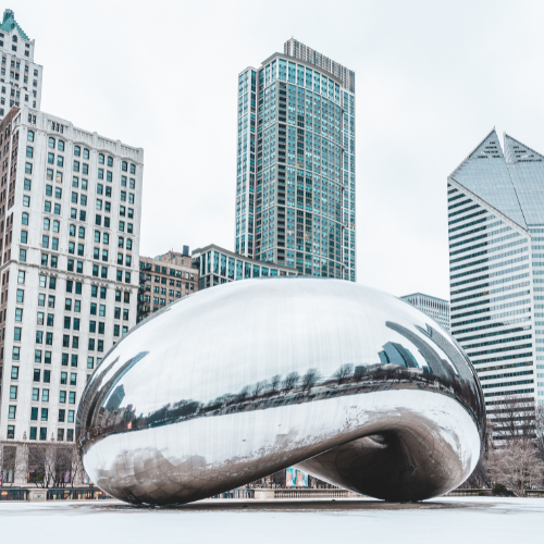 Cloud Gate sculpture (“The Bean”) in Chicago’s Millennium Park surrounded by city skyscrapers