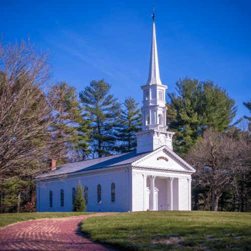 Historic White Church in Sudbury, MA under Blue Sky