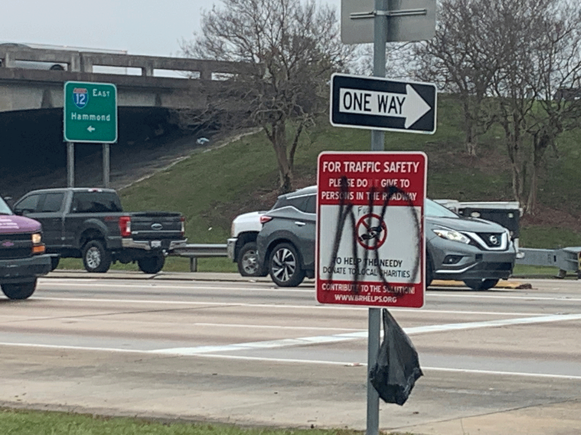  A vandalized sign at the ramp of I-12 and Sherwood Forest Blvd. 