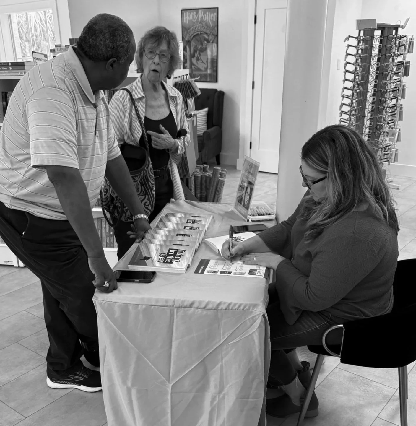 April Capochino Myers talking with people at a book signing