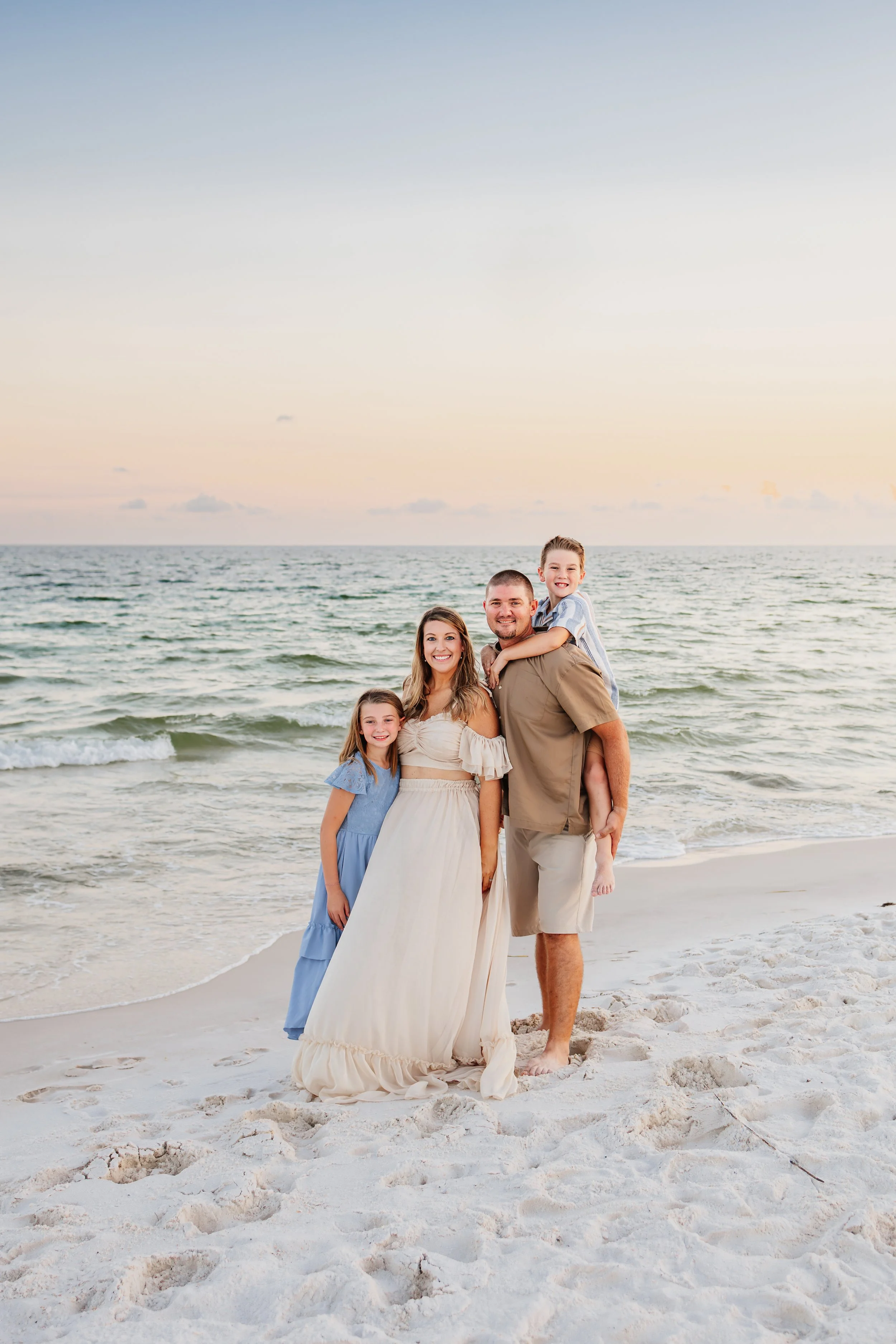 Young family having a photo session with a Pensacola Beach Photographer and Navarre Beach Photographer in Pensacola, FL