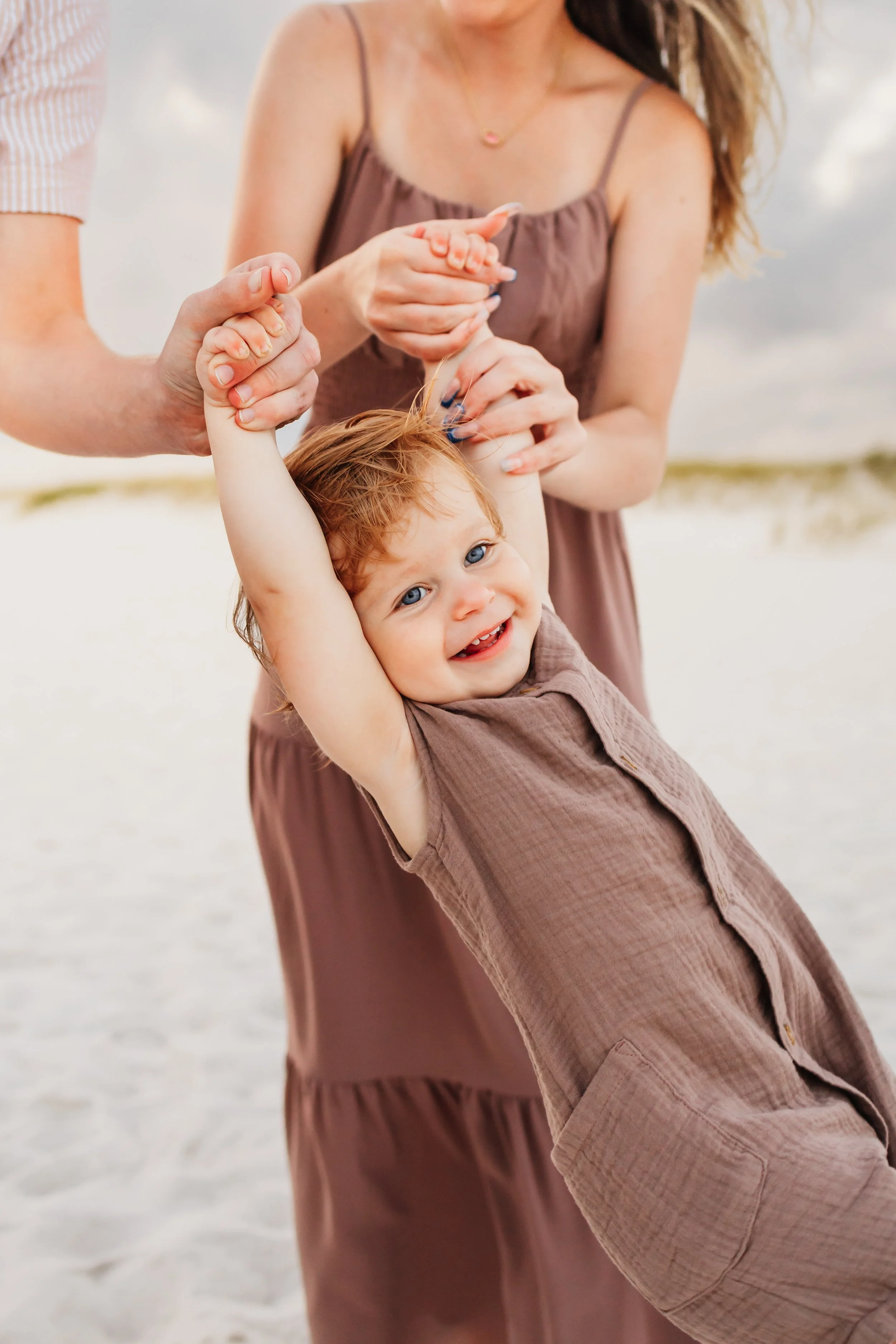 Young family having a photo session with a Pensacola Beach Photographer and Navarre Beach Photographer in Pensacola, FL