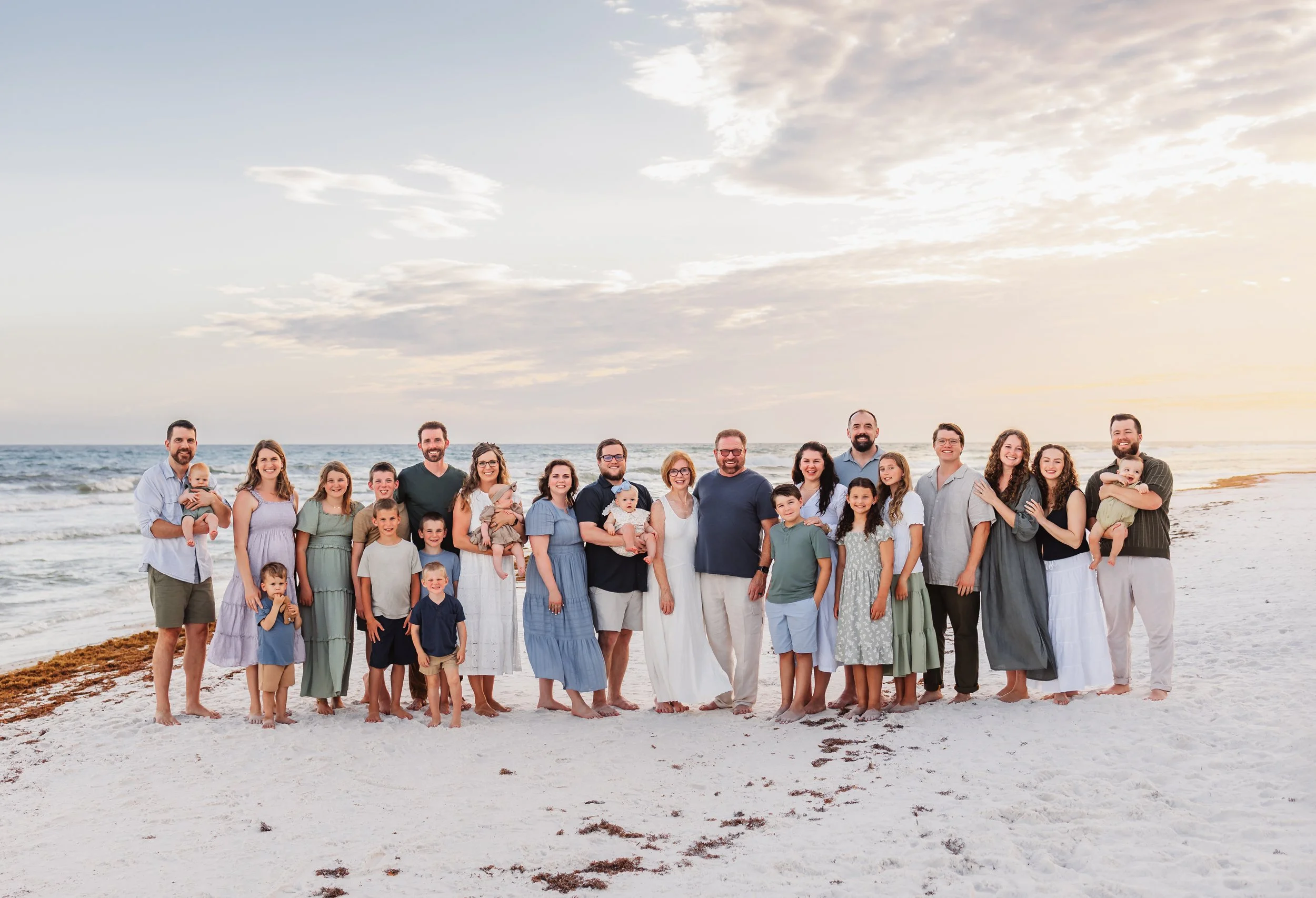 A multigenerational family posing for a picture on Pensacola Beach with Kristen Coberly Photography