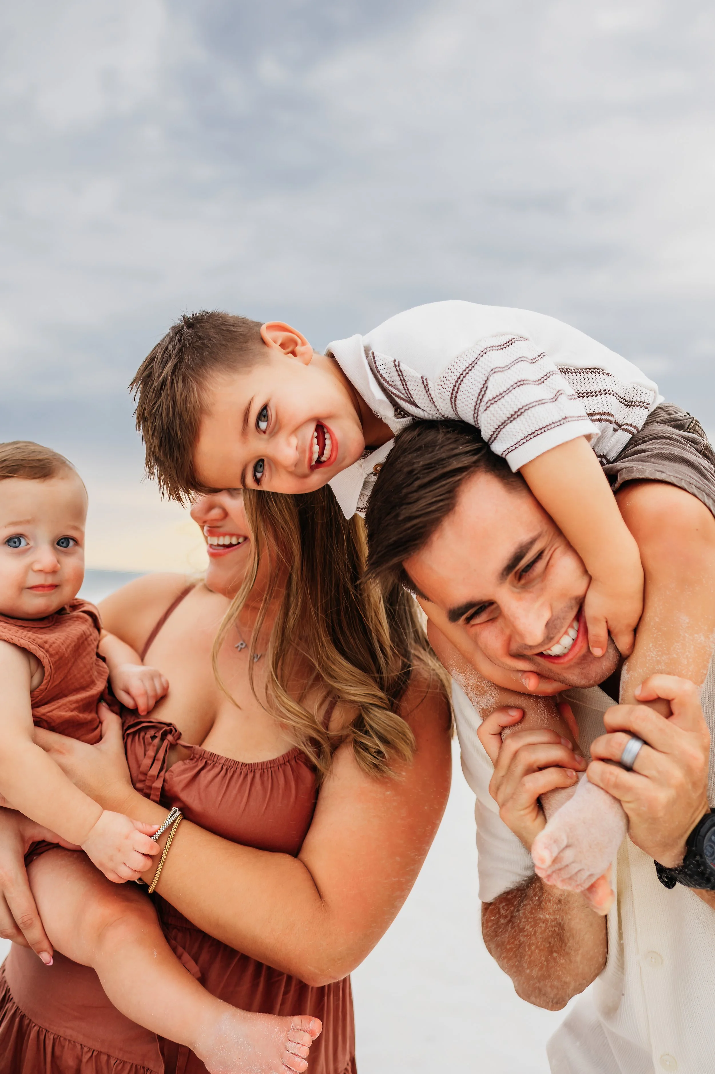 Young family having a photo session with a Pensacola Beach Photographer and Navarre Beach Photographer in Pensacola, FL
