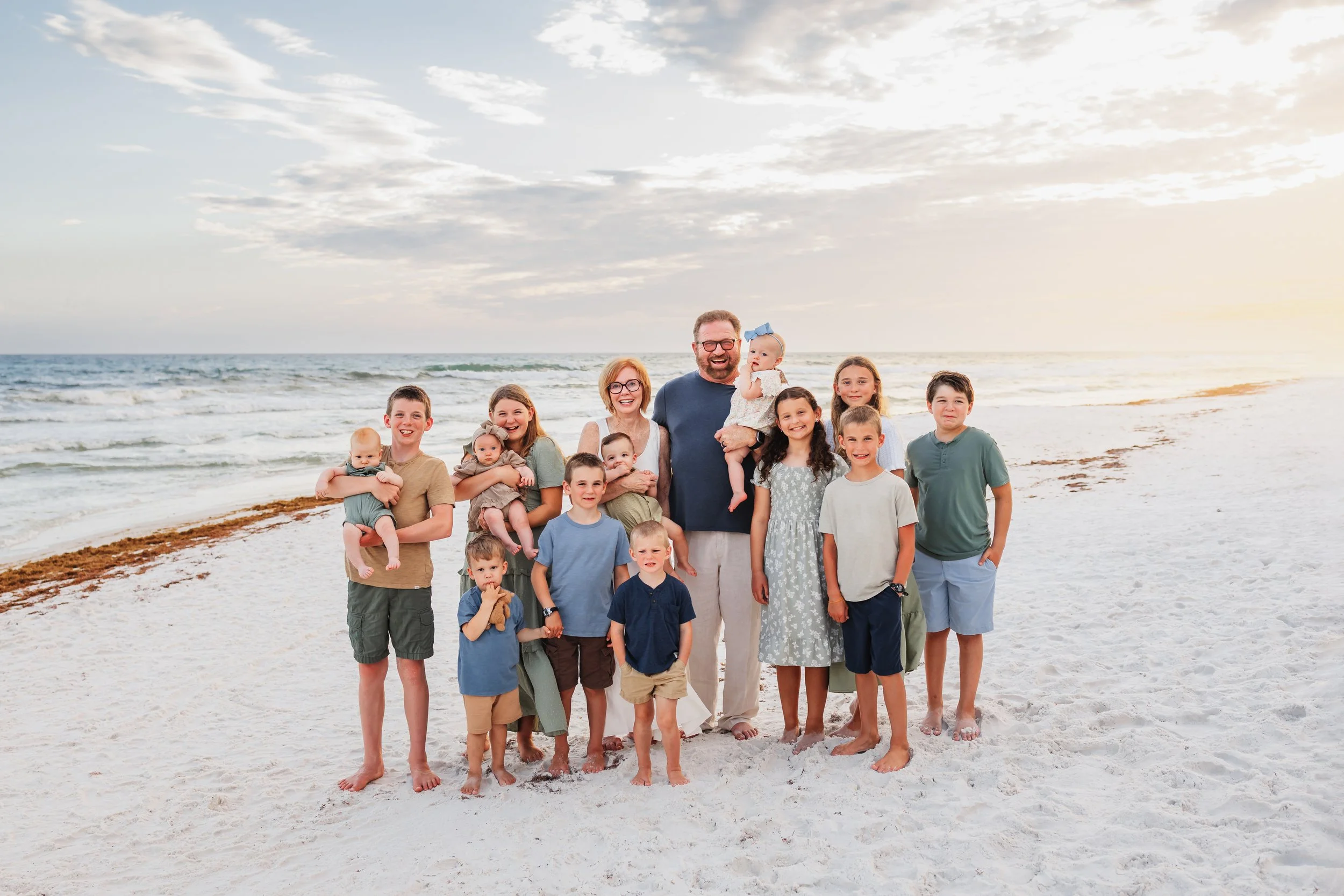 Grandparents with multiple grandkids posing for a picture on Pensacola Beach with Kristen Coberly Photography
