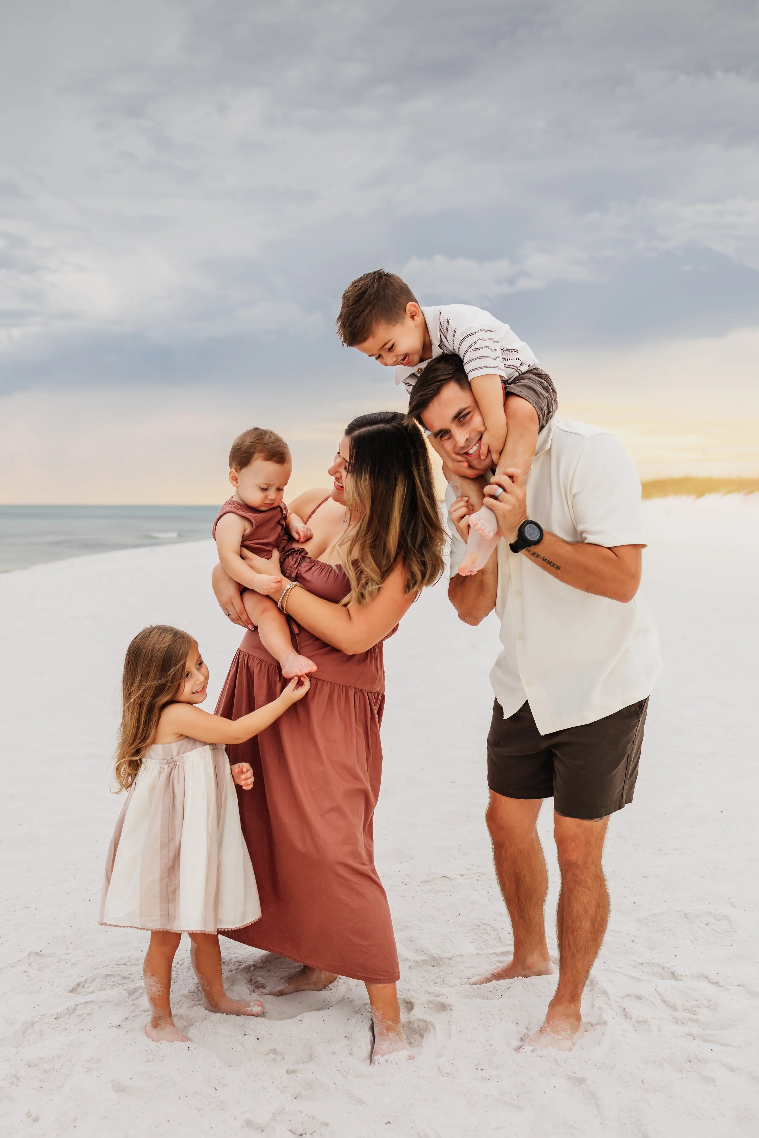 Young family having a photo session with a Pensacola Beach Photographer and Navarre Beach Photographer in Pensacola, FL