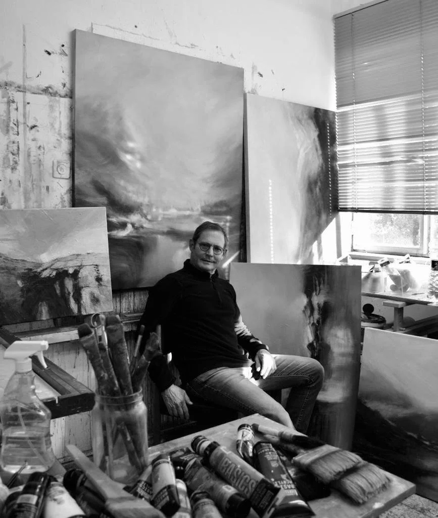 Noam in the studio working on commissioned paintings.