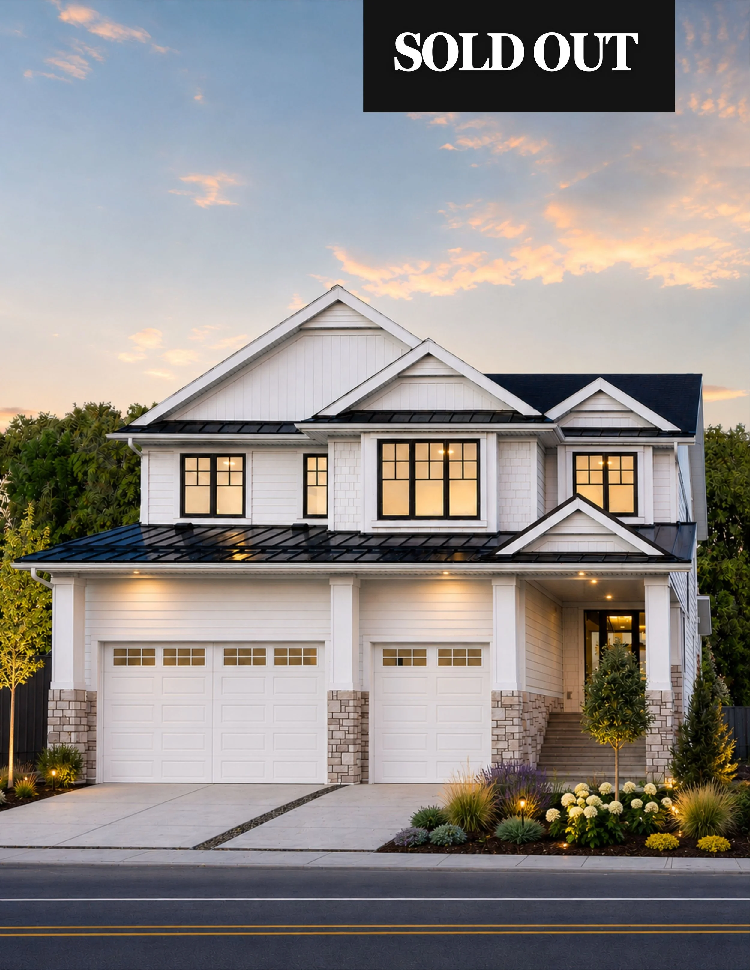 A modern two-story white house with black window frames, a garage with a white door, and a landscaped front yard with flowers and small trees. The house has a black roof and is illuminated from within. There is a "SOLD OUT" sign at the top right corner of the image.