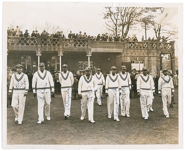 Lot 514

All India tour to England 1936. Original sepia press photograph depicting ten of the Indian team walking on to the field for the opening match of the 1936 tour v A.P. [Tich] Freeman's XI at the Bat and Ball Ground, Maidstone, 29th April 1936