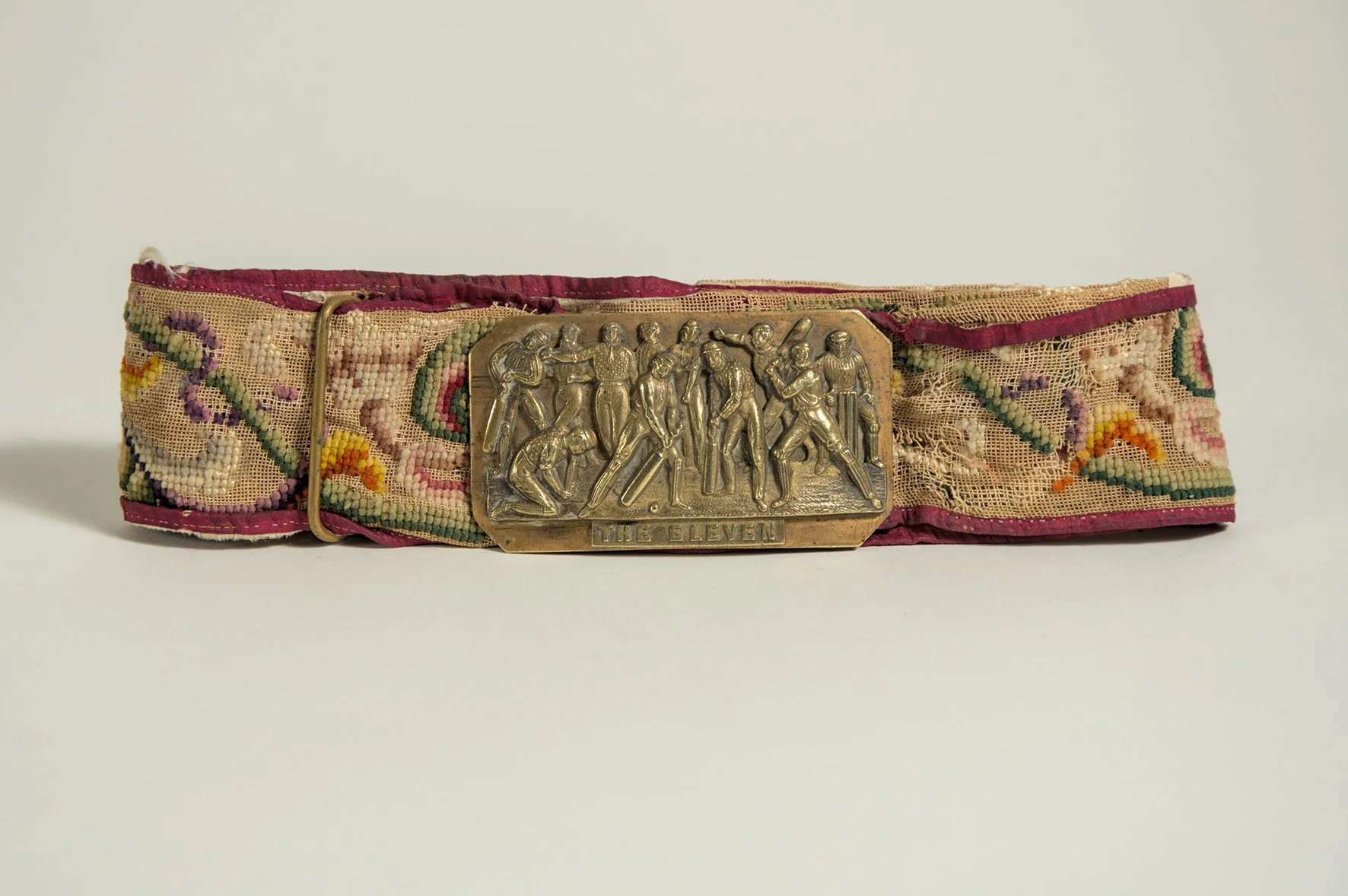 Lot 447

'The Eleven'. Early and complete embroidered belt with oblong shaped brass belt buckle showing the eleven players, shown as batsmen, fielders, bowlers and wicket-keeper, with legend to lower border. The buckle measures almost 3.5"x2". The co