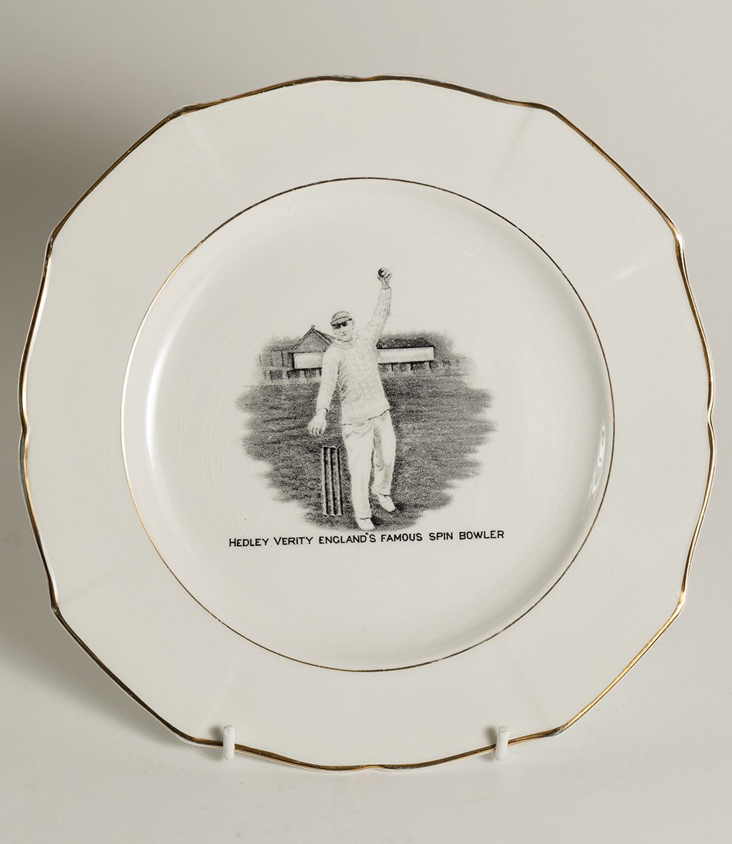 Lot 789

Hedley Verity, Yorkshire & England. Unusual commemorative ceramic plate for ‘Hedley Verity, England’s Famous Spin Bowler’ with transfer printed vignette of Verity in bowling pose and title to face. Gold lustre to inner and outer rim. To vers