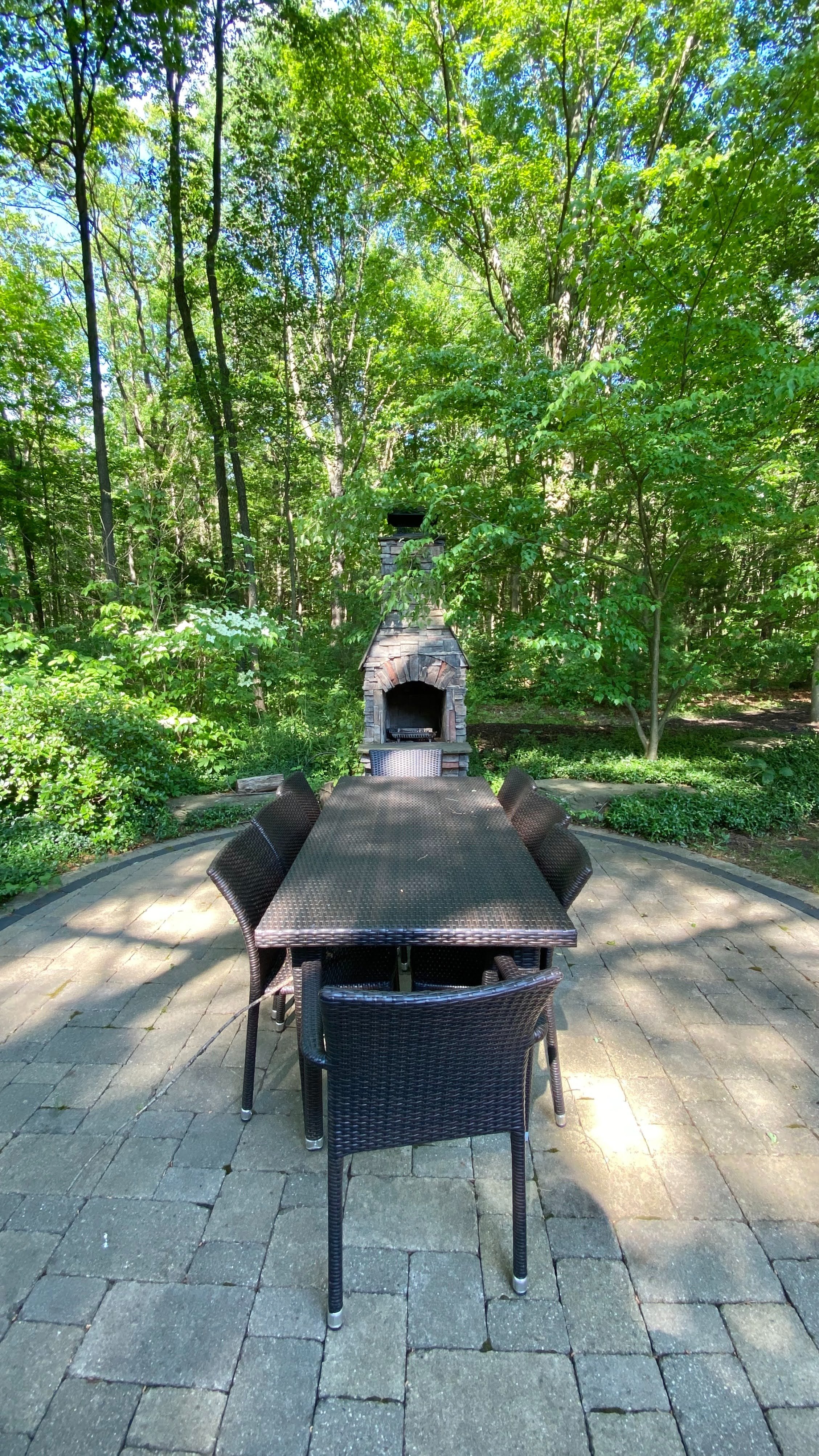 Outdoor dining table with a stone fireplace