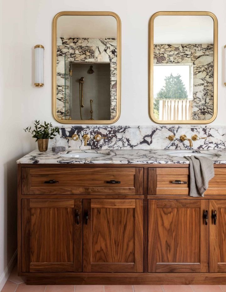  This is my favorite countertop by far- I really want a statement marble or something similar looking!  Also love the back-splash continuation up the wall! 