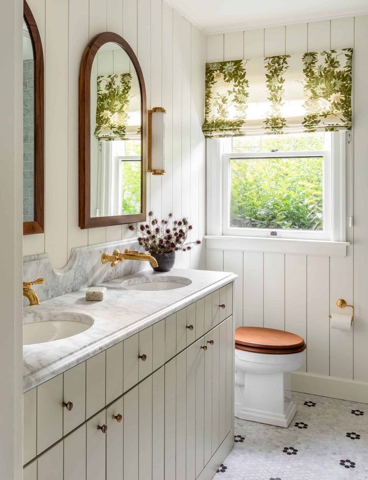  I adore the countertop in here with backsplash extended up (I really want to do this on ours as well and love the more unique arched/scalloped detail on the backsplash.  I also love the lighting, mirrors, and color of the vanity.  I think adding som