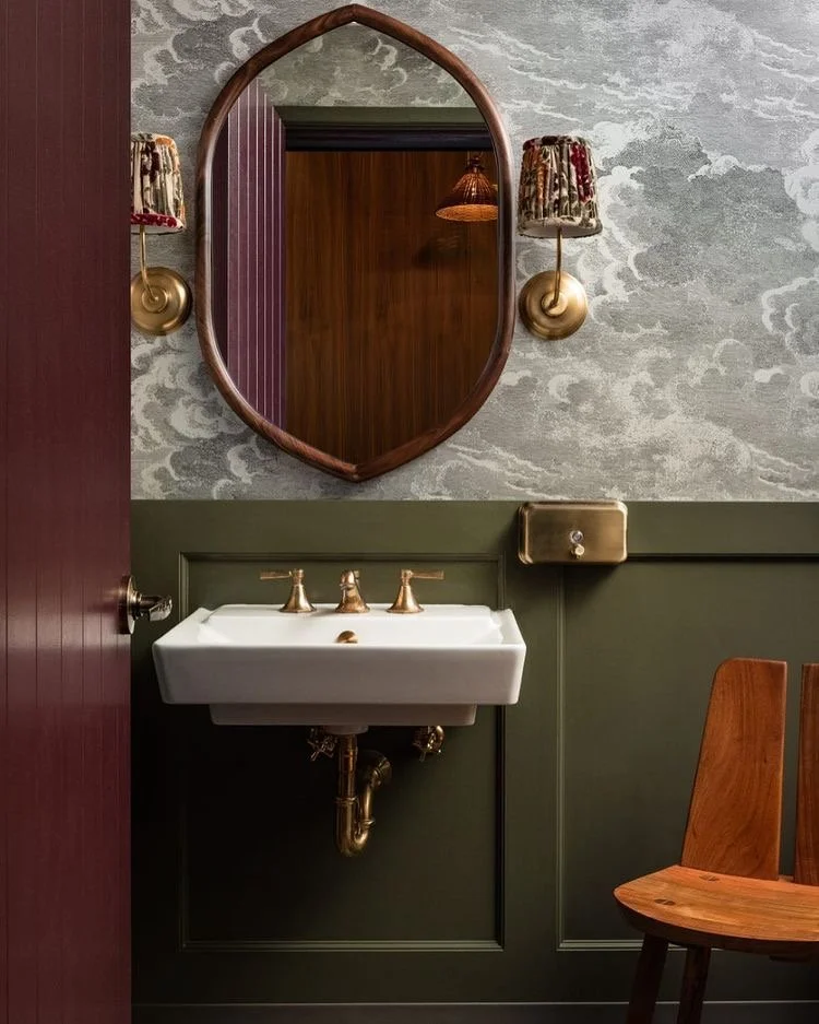  I love the moody vibe of this space. The paint colors, wallpaper, and sconce combo is so good! I definitely want to make this space feel a little more masculine since it is something Alex and I share daily and I have basically put flower prints ever