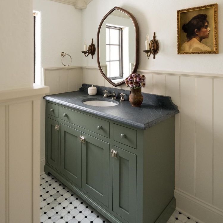  I love this taupe trimwork mixed with the green vanity, dark countertops, and antique sconces and mirror! 
