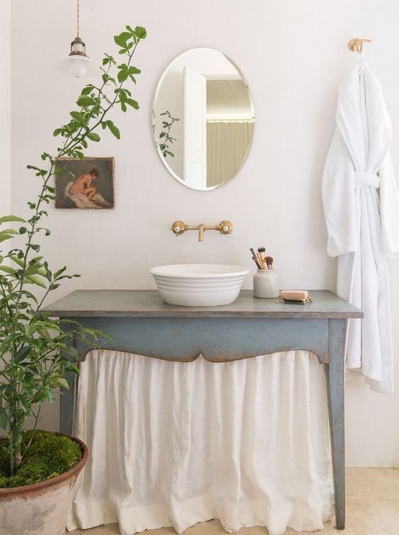  I love the pop of color on this vanity and also love the idea of a skirted vanity too! This would give us more storage underneath and could allow me to use the same fabric from the window treatment again in the space! 