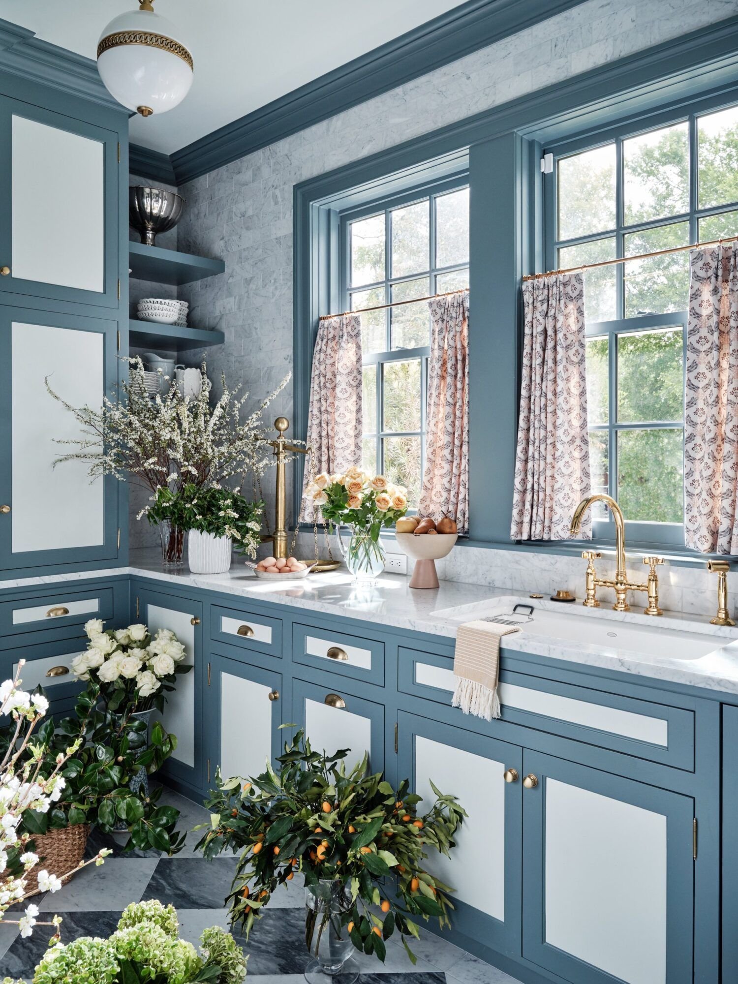 More two-toned cabinets, love the window treatments, and overall layout.