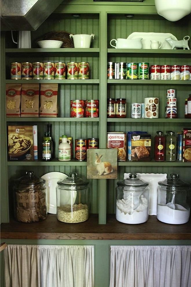Love this green and the open shelving storage with jars and skirted lowers.