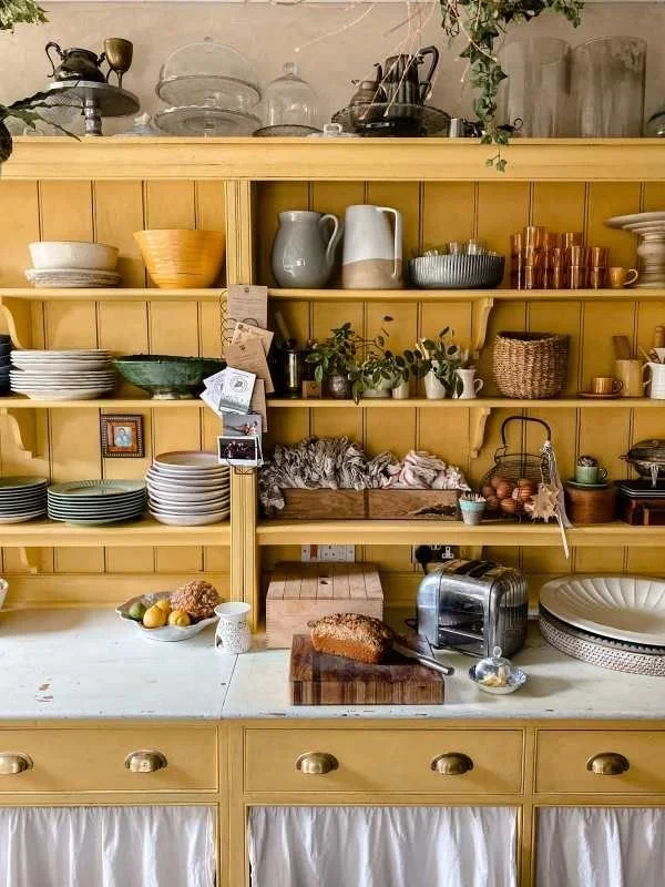 This is the exact color I'm in love with! The perfect mustard yellow- and skirted cabinets too!