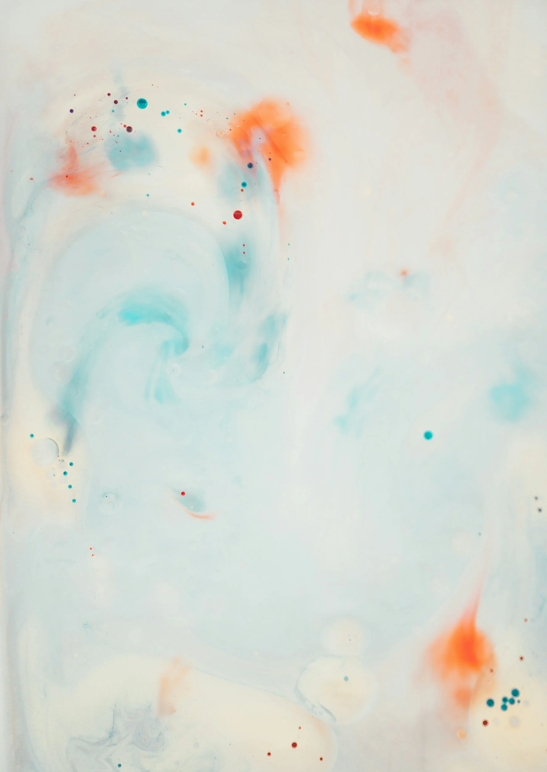 Abstract watercolor painting with light pastel blue, orange, and red splashes and dots on a white background.