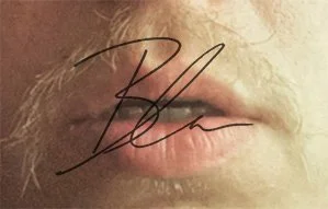 Close-up of lips with an autograph or signature written over them