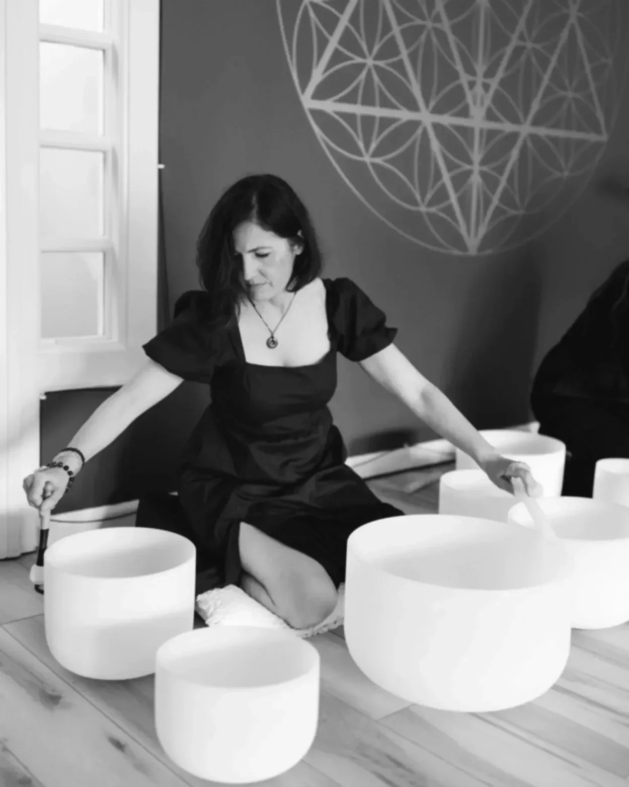 a woman plays crystal sound bowls to produce binarual beats in millcreek ut