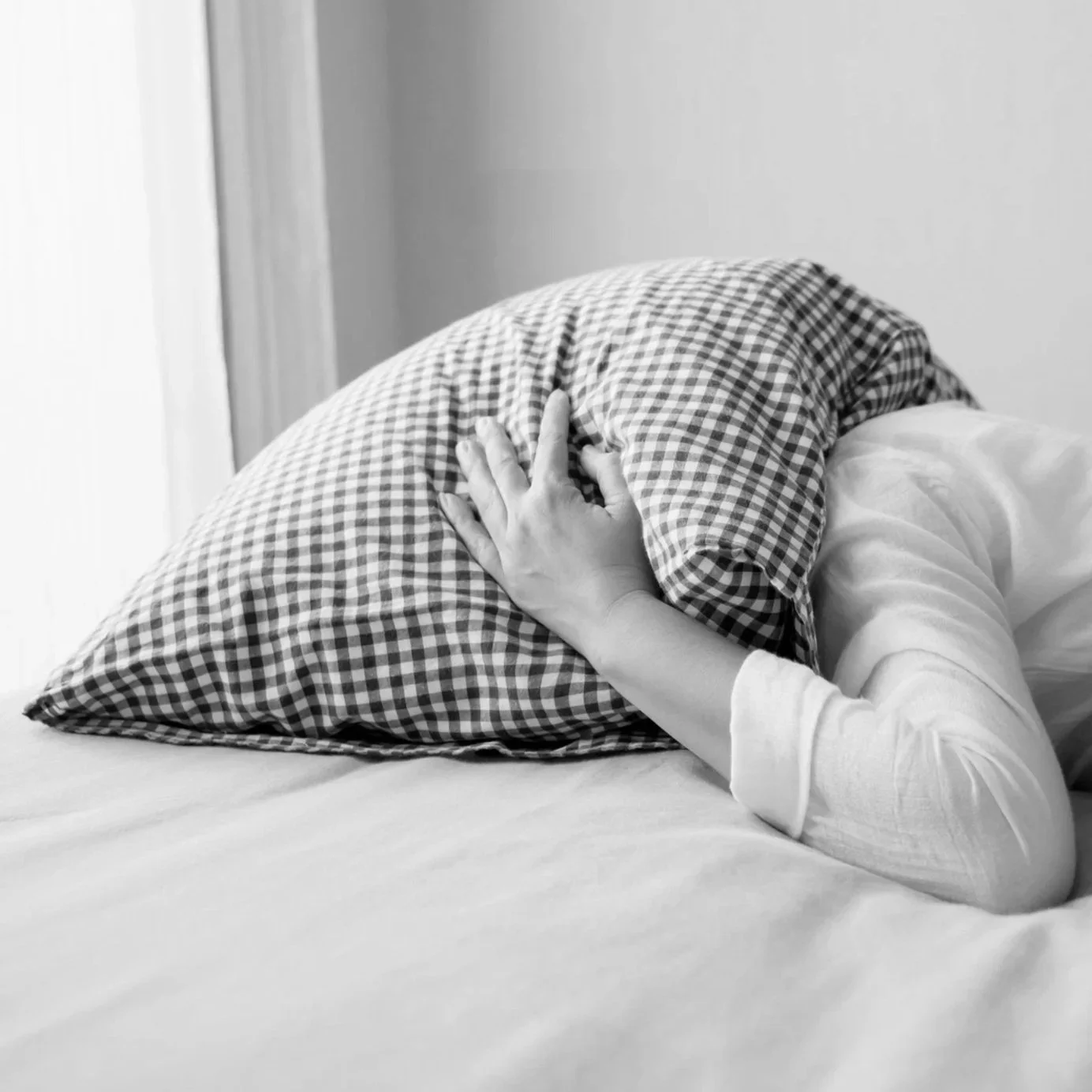 Person laying in bed awake struggling from insomnia.