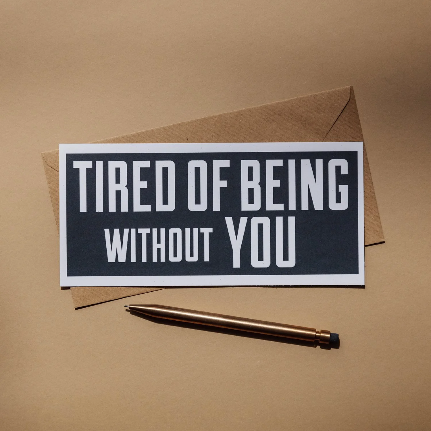 Tired of Being Without You typographical flat greetings card by Alfie’s Studio. Text is white on a black background with a white border.