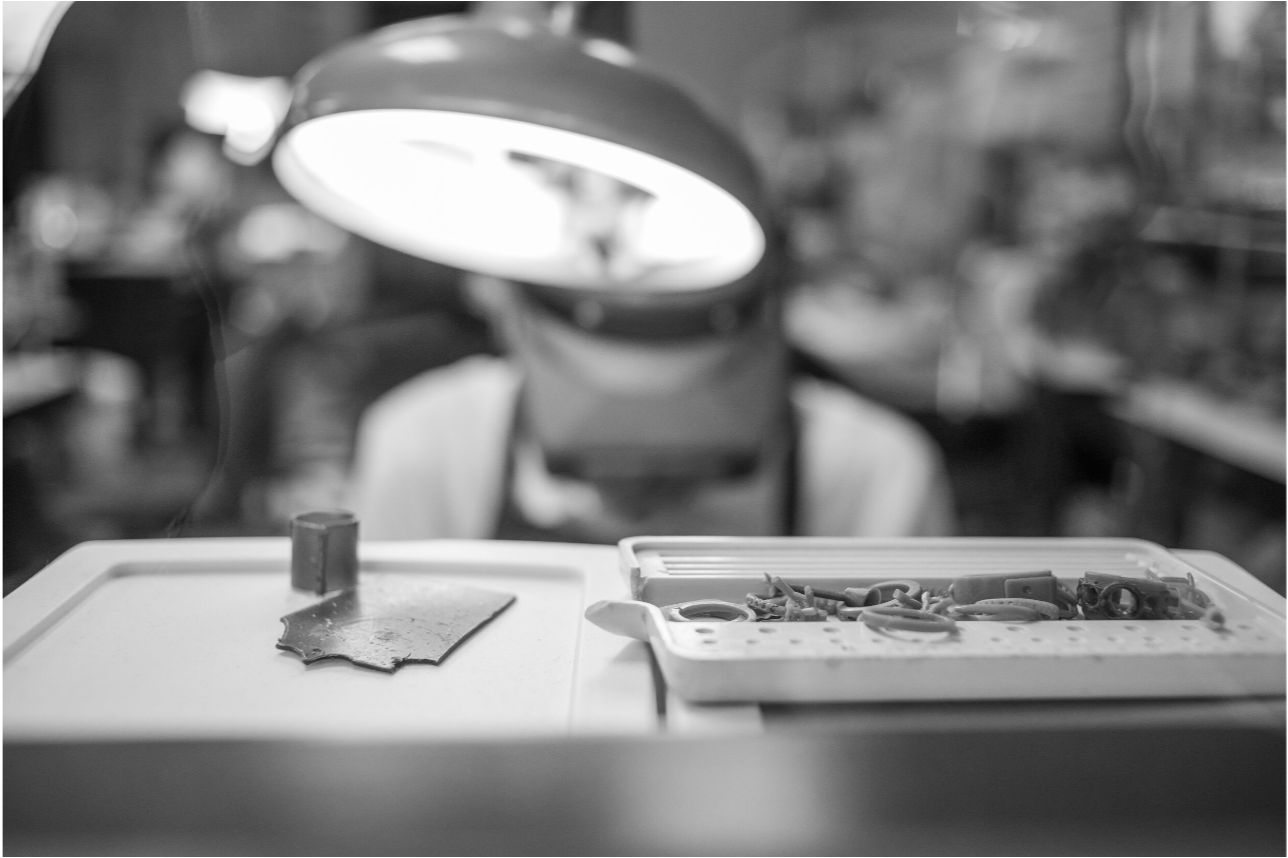 Master gold smith Larry Stark working on his bench on a piece of custom jewelry in his studio in Sacramento