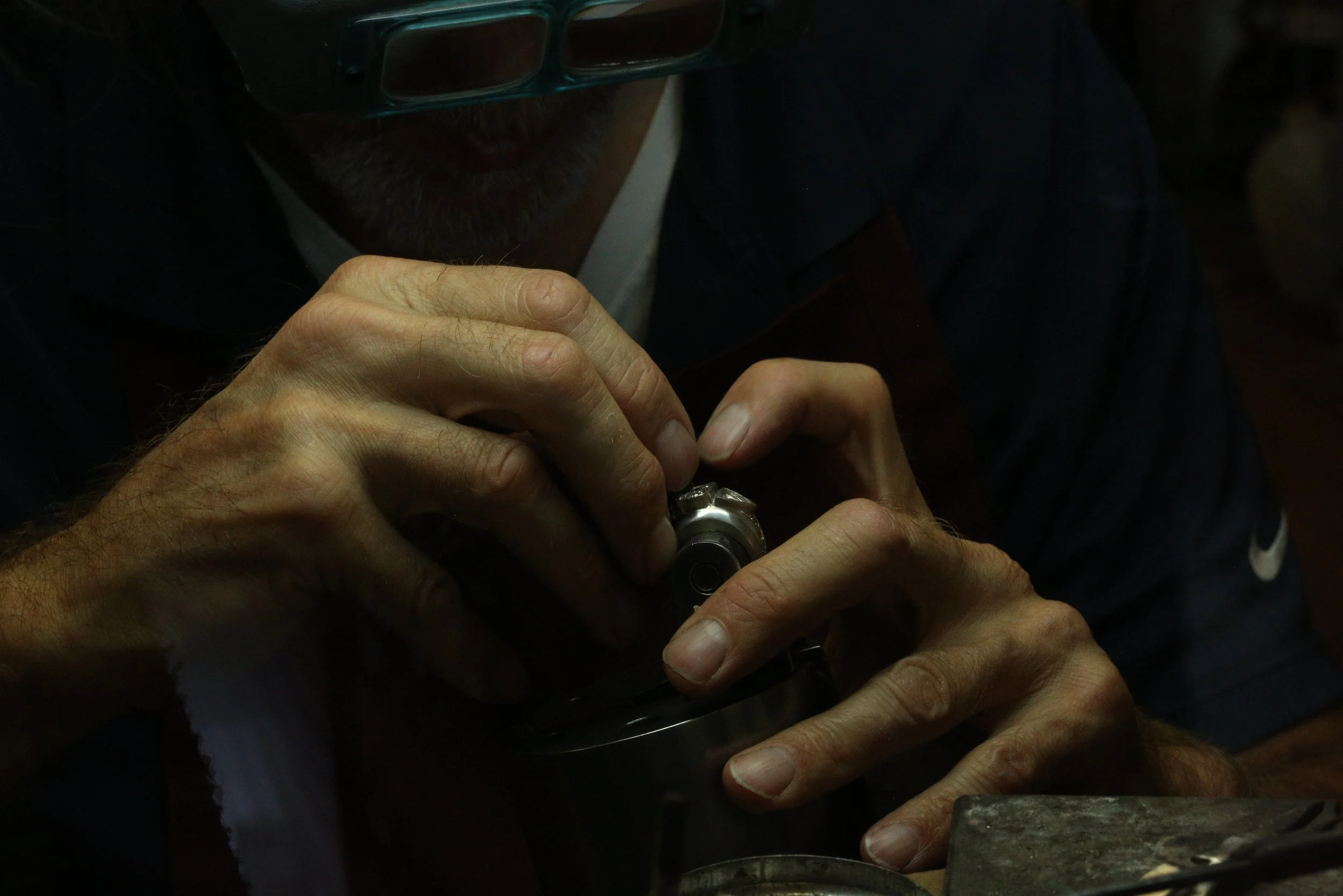 In Stark Jewelers Studio located in Sacramento, Master goldsmith Larry Stark is working on jewelry at a workbench for custom jewelry and expert repairs