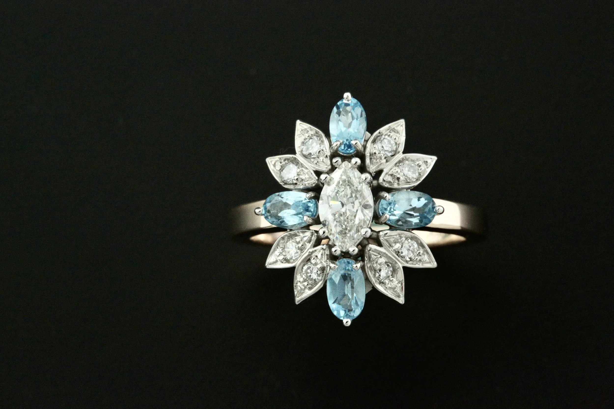 The final custom heirloom engagement ring featuring a stunning sunburst pattern of aquamarines and brilliant diamonds.