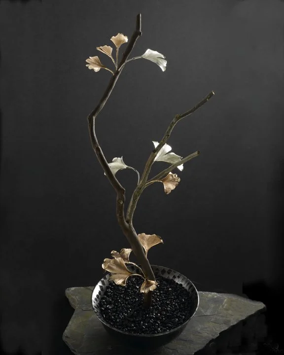 Wisdom - One of A Kind
Sterling silver and copper

Ikebana bonsai art beautifully combines nature's elegance with artistic expression. Each masterpiece features hand forged and engraved silver and copper ginkgo leaves that dance delicately in harmony
