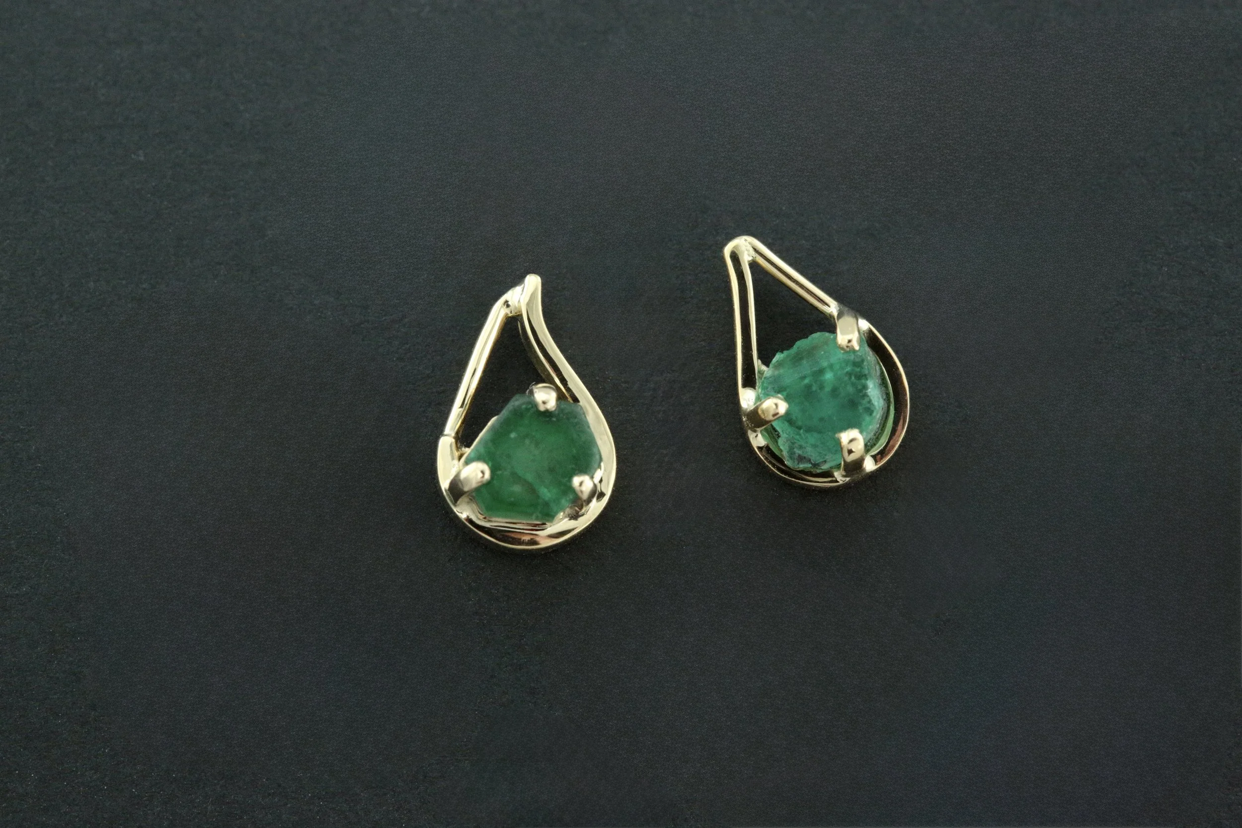 Our jewelers carefully combed through loose raw gemstone inventory to source a natural emerald rough that mirrored the client's remaining earring. The result is a seamless match.