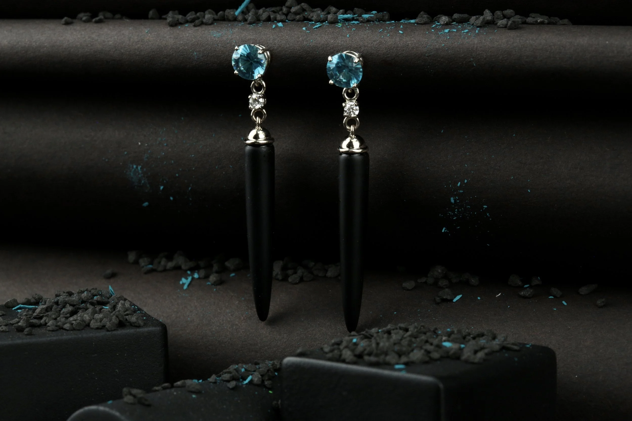 Pair of black onyx dangling earrings with blue zircon and diamonds designed and handmade by stark jewelers