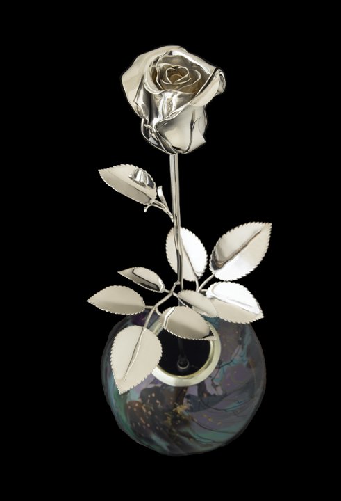 The exquisite sterling silver rose was beautifully hand crafted and elegantly showcased in a stunning, handcrafted colored glass vase.
