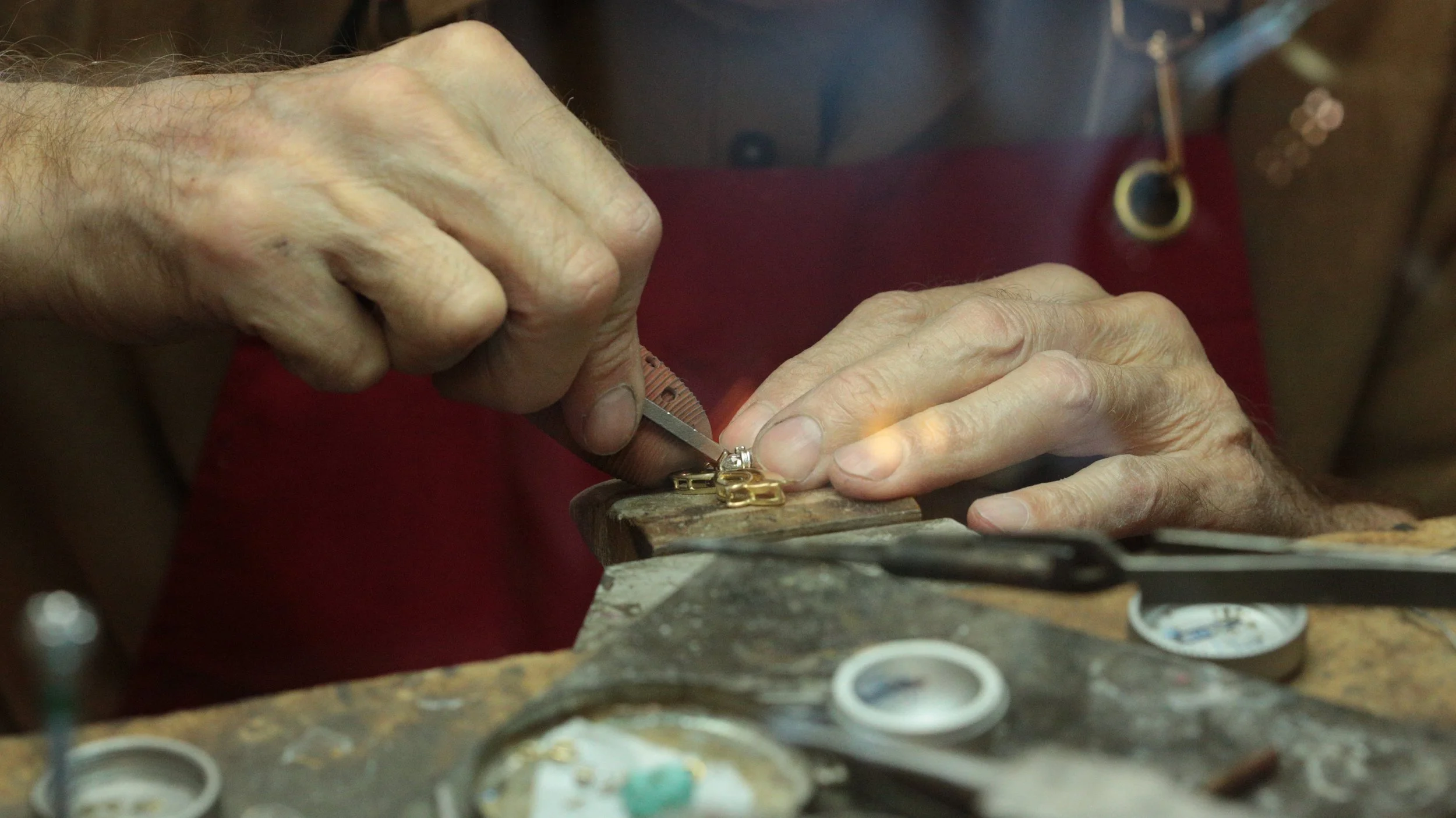 Setting a 3-carat diamond precisely on a jeweler's bench in our studio in Sacramento.