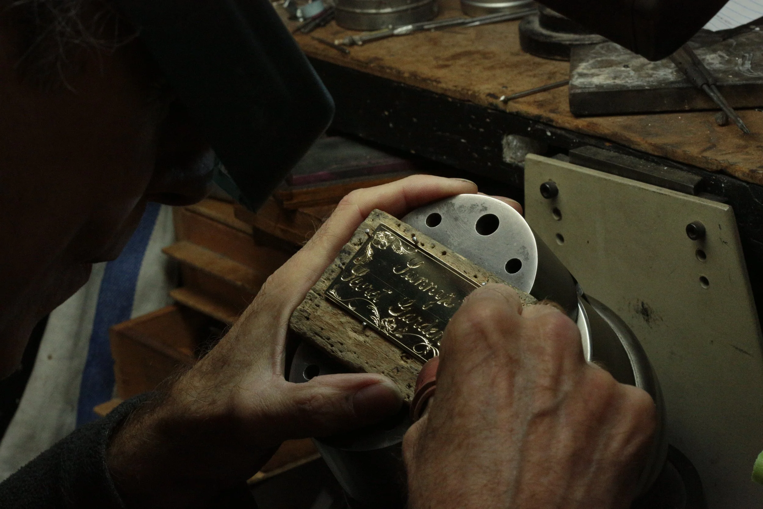 Master gold smith Larry Stark working on his bench for jewelry engravings in his studio in Sacramento