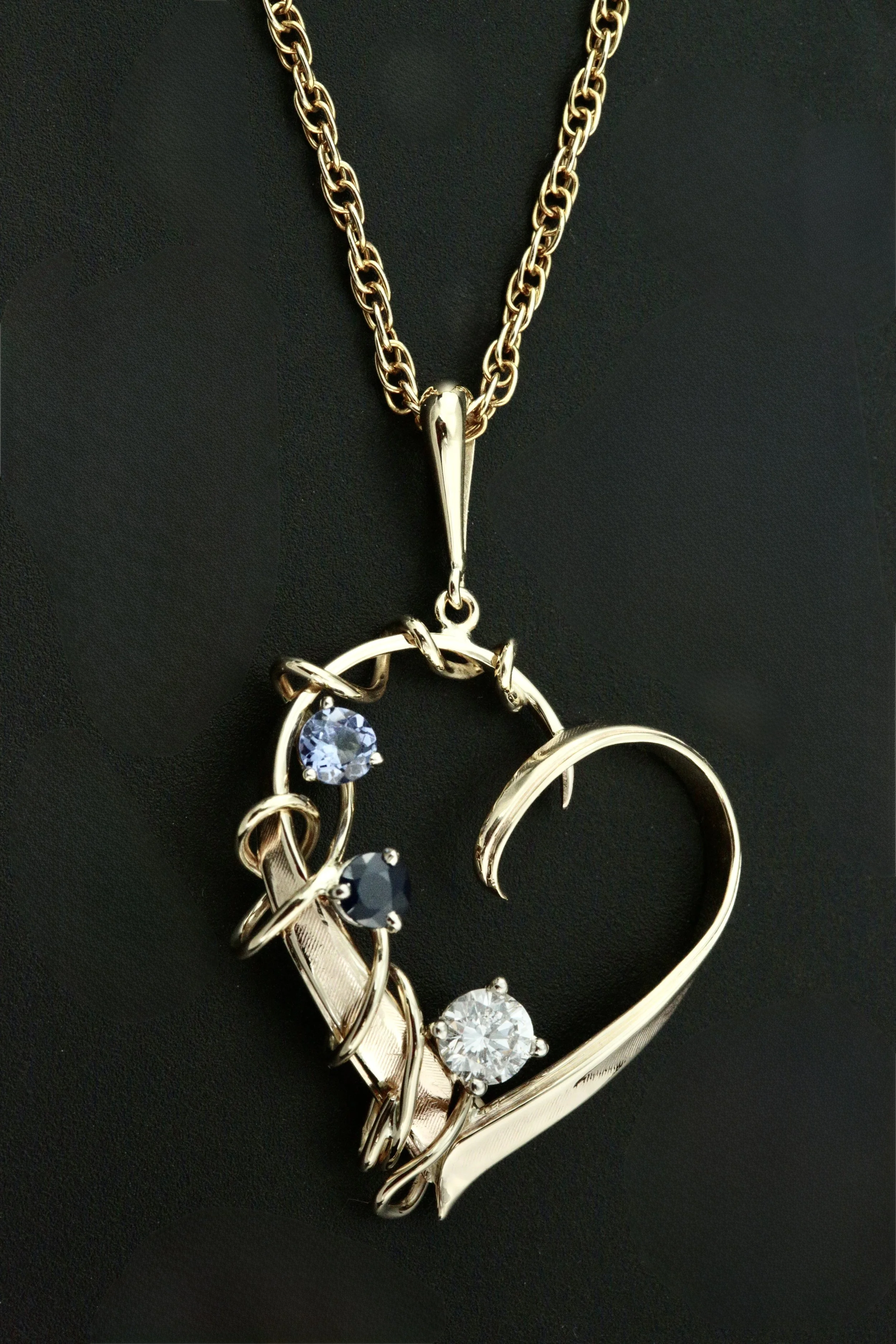 custom make 14k yellow heart shape pendant from a late husband's wedding ring and their kids' birth stones, sapphires and diamonds designed and crafted by Stark Jewelers in Sacramento 