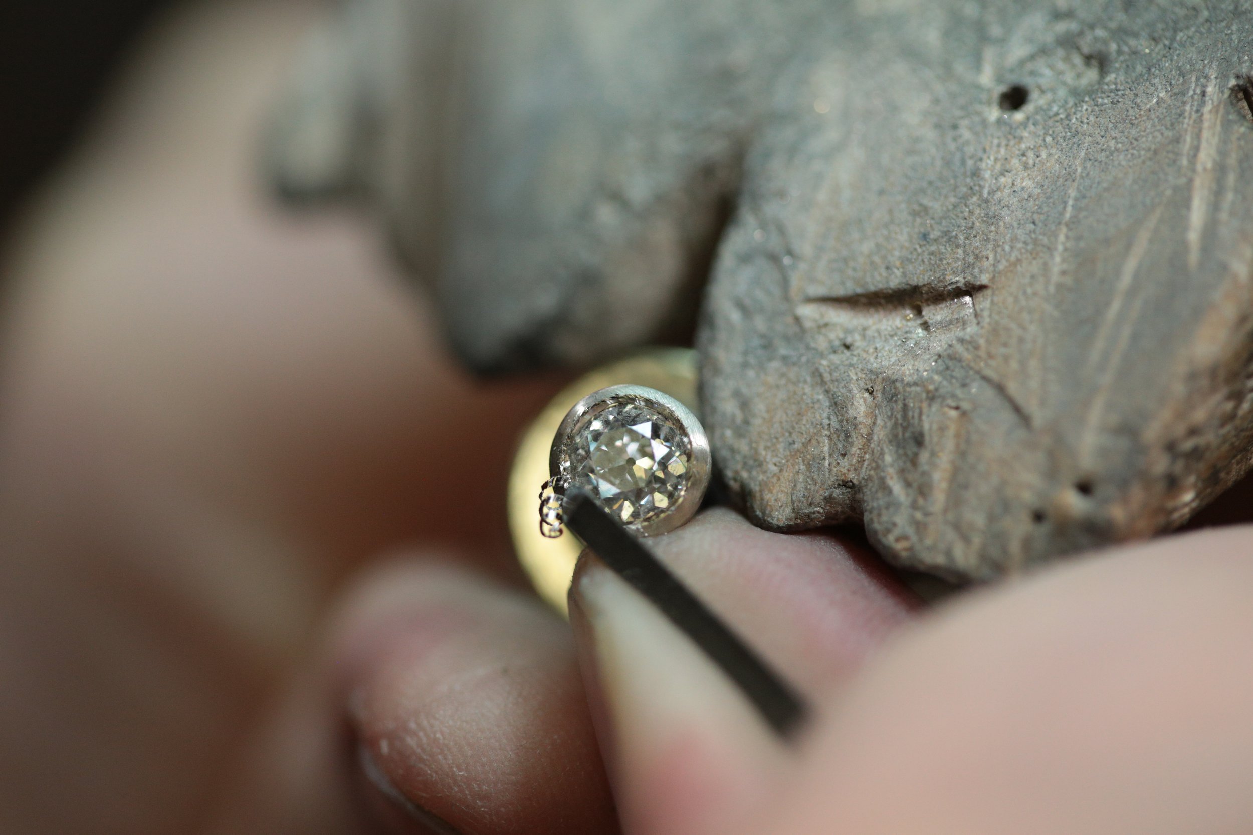 Expert hand setting in a bezel from a custom design at Stark Jewelers in Sacramento