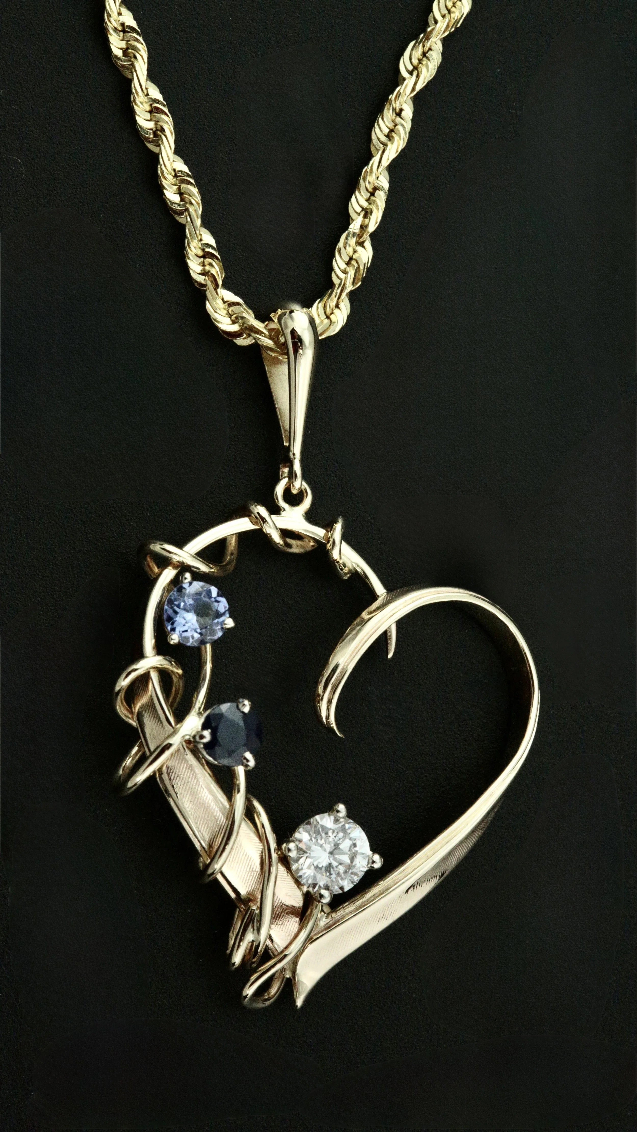 Heirloom transformation from estate jewelry to a beautiful heart pendant with children's birth stones from the client's idea at Stark Jewelers in Sacramento