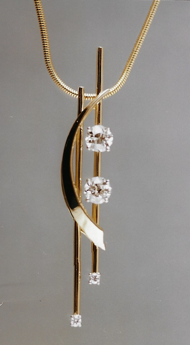 Gold necklace with a pendant featuring a curved design, three diamonds, and vertical gold bars.