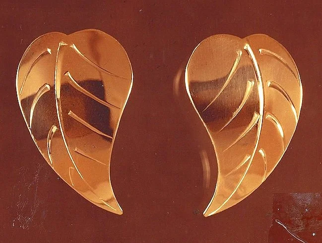 pair of gold eaf-shaped decorative earrings with hand engraved patterns designed and handmade by stark jewelers