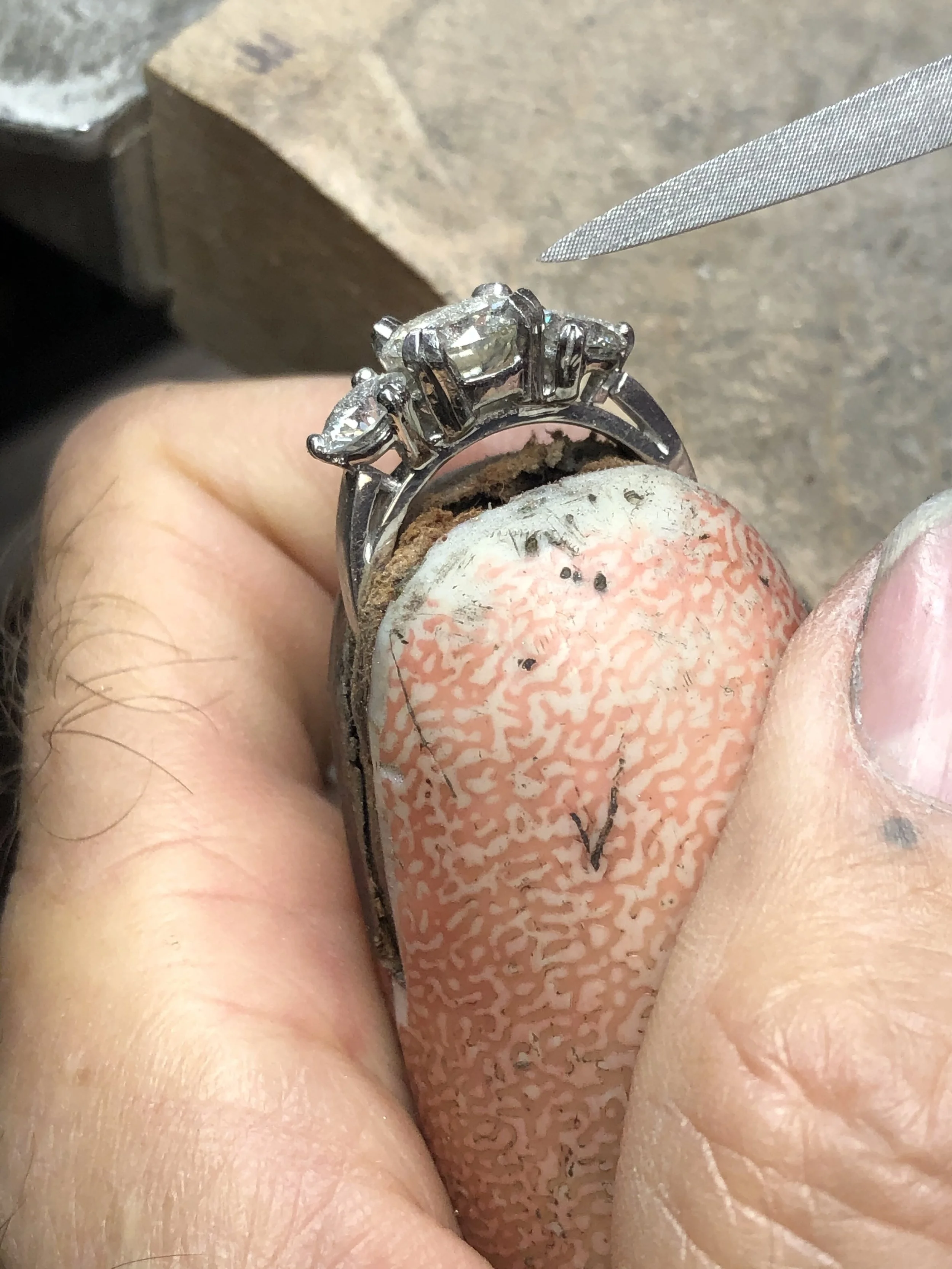 Expert hand setting of diamonds in custom jewelry at Stark Jewelers in Sacramento