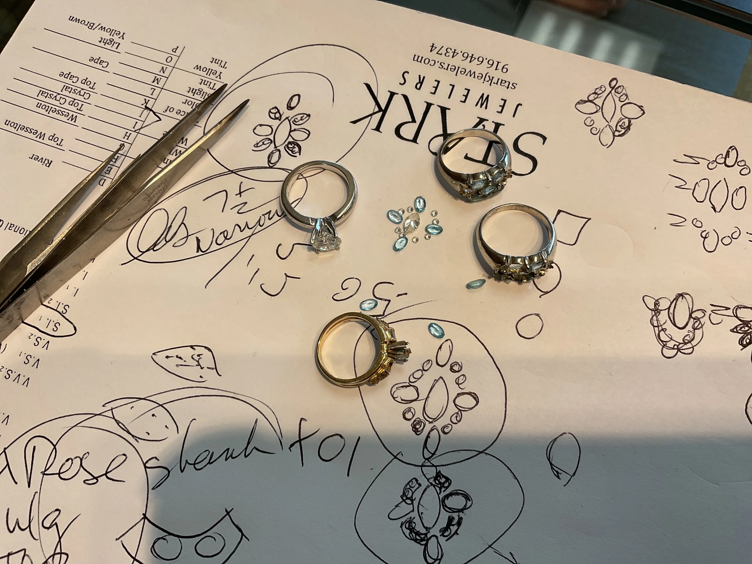 The beginning of a transformation—mapping out loose diamonds and aquamarines alongside original family rings at Stark Jewelers.