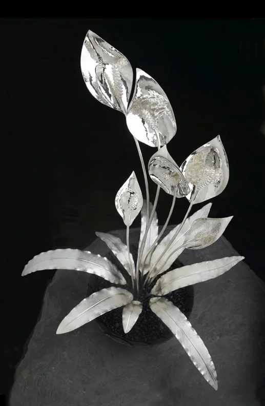 Transform your space with the exquisite hand-sculpted Peace Lily Masterpiece, featuring detachable brooches for a touch of elegance in any setting.