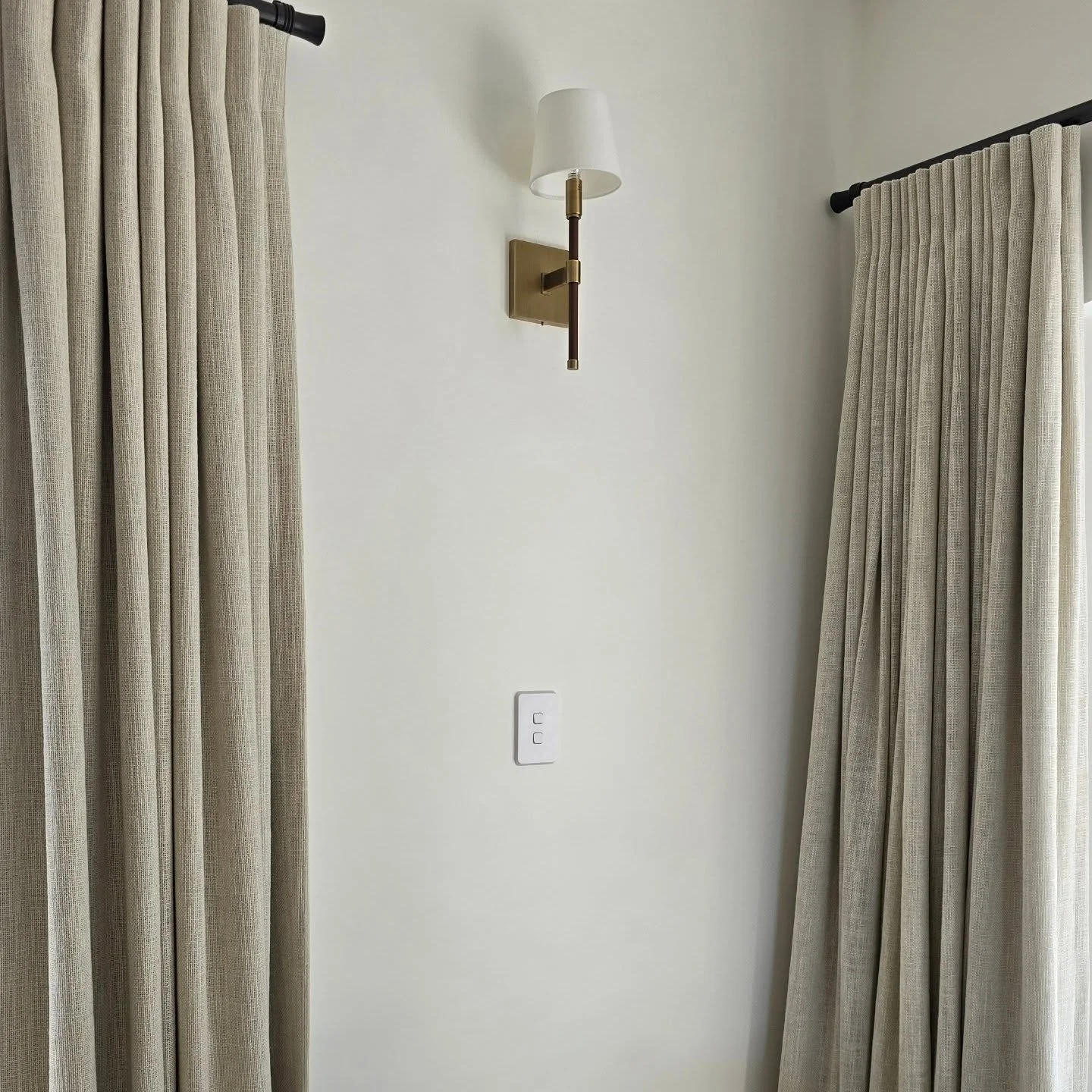 How subtle changes in a renovation can breathe new life into a space. Swapping an existing wall light for something gentler and more elegant, changing heavy, polyester curtains for a neutral linen-blend and painting the walls a creamy white. The ener