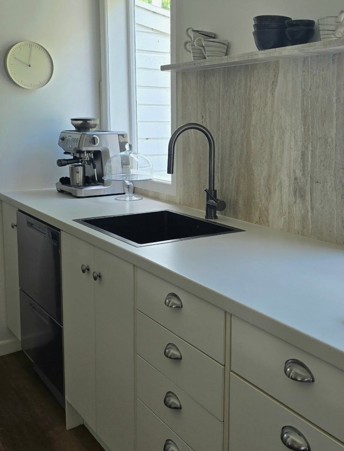 Sometimes it can take only one change to a room to shift the whole feeling in the space. Here I've added a honed travertine splashback and shelf to the kitchen bench area. It's a quiet, peaceful change, but it's instantly elevated the whole kitchen a