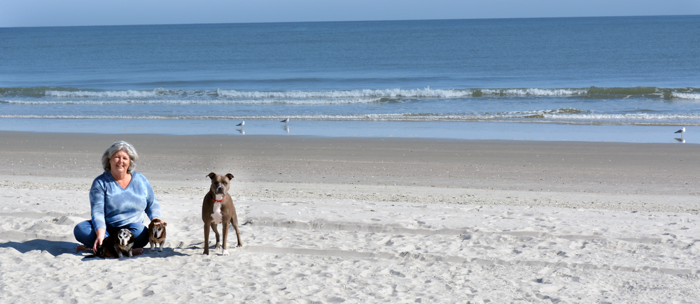 Dana Brigman with her dogs on the beach